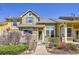 Charming townhome featuring a stone facade, covered porch, and well-maintained landscaping at 720 Reid Pl, Castle Rock, CO 80108