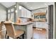 Well-lit kitchen featuring granite countertops, hardwood floors, and stainless steel refrigerator at 720 Reid Pl, Castle Rock, CO 80108