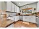Bright kitchen with white cabinets, granite countertops, stainless steel appliances, and hardwood floors at 720 Reid Pl, Castle Rock, CO 80108