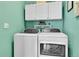 Laundry room with washer, dryer, and ample cabinet space at 720 Reid Pl, Castle Rock, CO 80108