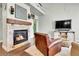 Living room featuring a fireplace with stone surround and a TV console with barn door accents at 720 Reid Pl, Castle Rock, CO 80108