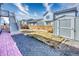 Fenced backyard with a gravel area, shed, and staircase to a deck, offering a private outdoor space at 9227 Salida St, Commerce City, CO 80022