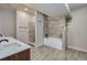 Modern bathroom with tiled shower, soaking tub and neutral finishes at 9227 Salida St, Commerce City, CO 80022