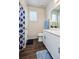 Bathroom with a shower/tub, white vanity and wood-look vinyl floors at 9227 Salida St, Commerce City, CO 80022