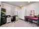 Well-lit bedroom featuring a desk, ample storage, and soothing floral curtains for a relaxing ambiance at 9227 Salida St, Commerce City, CO 80022