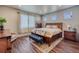 Bedroom with a queen-size bed, wood-look floors and neutral walls at 9227 Salida St, Commerce City, CO 80022