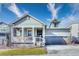 A home with gray siding and brick accents, complemented by a landscaped front yard and inviting entrance at 9227 Salida St, Commerce City, CO 80022