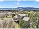 Scenic aerial view of a home with a deck and mountain views in the background at 18750 Spring Valley Rd, Monument, CO 80132