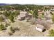 Aerial shot of a house with a well-kept yard and a separate storage shed at 18750 Spring Valley Rd, Monument, CO 80132