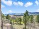 A view from the back porch with mountain views and evergreen trees at 18750 Spring Valley Rd, Monument, CO 80132