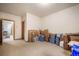 Unfinished basement area featuring carpeted floors and multiple doors leading to other areas of the basement at 18750 Spring Valley Rd, Monument, CO 80132