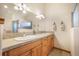 Bright bathroom featuring double sinks, granite countertop and tile floors at 18750 Spring Valley Rd, Monument, CO 80132