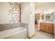 Bathroom featuring a soaking tub and wood cabinets at 18750 Spring Valley Rd, Monument, CO 80132