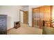 Bedroom with carpeted floors, a large window and two wood doors leading to other areas of the home at 18750 Spring Valley Rd, Monument, CO 80132