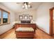 Bright bedroom with a wooden bed, wooden floors and multiple windows at 18750 Spring Valley Rd, Monument, CO 80132