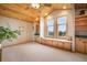 Bright bonus room with a built-in window seat, cabinets and shelves, and large windows to enjoy the scenery at 18750 Spring Valley Rd, Monument, CO 80132