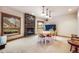 Inviting dining room featuring a stone fireplace, carpeted floors and a white table set for six at 18750 Spring Valley Rd, Monument, CO 80132