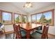 Bright dining room with beautiful views from multiple windows and a large, inviting table at 18750 Spring Valley Rd, Monument, CO 80132