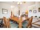 The dining room features natural lighting, an attractive wood table, and access to other living spaces at 18750 Spring Valley Rd, Monument, CO 80132