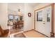 Welcoming foyer featuring a decorative front door and views of the dining area filled with natural light at 18750 Spring Valley Rd, Monument, CO 80132