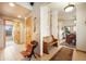 Inviting home foyer showcasing tile flooring, decorative bench, and views into the open dining room at 18750 Spring Valley Rd, Monument, CO 80132