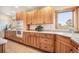 Kitchen features custom wood cabinets, a tiled floor and granite countertops at 18750 Spring Valley Rd, Monument, CO 80132