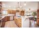 Bright eat-in kitchen boasts an island with gas cooktop, tile floors, and wood cabinetry at 18750 Spring Valley Rd, Monument, CO 80132