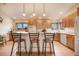 Spacious kitchen with island seating, bright lighting, and abundant cabinet space for all your culinary needs at 18750 Spring Valley Rd, Monument, CO 80132