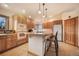 Well-lit kitchen features light wood cabinets, a central island with seating, and a suite of modern appliances at 18750 Spring Valley Rd, Monument, CO 80132