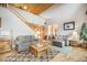 Comfortable living room features hardwood floors and a stairway to the second floor at 18750 Spring Valley Rd, Monument, CO 80132