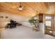 Loft with wood ceiling, an office and multiple windows at 18750 Spring Valley Rd, Monument, CO 80132