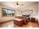 This main bedroom features a fan, a large window with a view, and wood flooring at 18750 Spring Valley Rd, Monument, CO 80132