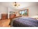 This main bedroom is filled with natural light and has a fan and wooden floors at 18750 Spring Valley Rd, Monument, CO 80132