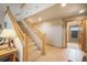 A wide staircase leads to an upper level with high ceilings and an exterior entrance at 18750 Spring Valley Rd, Monument, CO 80132