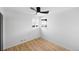 A bright bedroom featuring neutral walls, a ceiling fan, and hardwood flooring at 5505 Brentwood St, Arvada, CO 80002