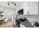 Modern kitchen with white cabinets, stainless steel appliances, and stylish backsplash at 5505 Brentwood St, Arvada, CO 80002