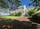 Attractive exterior of a well-maintained townhouse with lush landscaping and mature trees at 11113 E Alameda # 207, Aurora, CO 80012