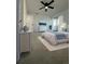 Comfortable main bedroom featuring neutral tones, a ceiling fan, and sliding door to balcony at 11113 E Alameda # 207, Aurora, CO 80012