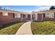 Inviting brick home featuring a covered porch, manicured shrubs, and a well-maintained walkway at 5425 County Rd 32 # 27, Mead, CO 80504