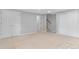 Spacious basement with carpet, three bright doors, and open staircase at 2717 S Langley Ct, Denver, CO 80210