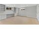 Spacious basement with carpet, storage shelving, desk, and window at 2717 S Langley Ct, Denver, CO 80210