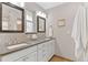 Bright bathroom featuring a double vanity with framed mirrors, mosaic tile backsplash, and modern fixtures at 2717 S Langley Ct, Denver, CO 80210