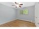 Bright empty bedroom featuring hardwood floors, modern ceiling fan, and window at 2717 S Langley Ct, Denver, CO 80210