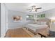 Serene bedroom featuring hardwood floors, a ceiling fan, and natural light at 2717 S Langley Ct, Denver, CO 80210