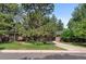 Traditional-style home with brick exterior, mature trees, and lush front lawn creating inviting curb appeal at 2717 S Langley Ct, Denver, CO 80210