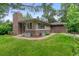 Charming single-story home with brick chimney, lush lawn, and mature trees providing shade at 2717 S Langley Ct, Denver, CO 80210