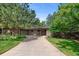 Well-maintained brick home with mature trees and a long driveway at 2717 S Langley Ct, Denver, CO 80210
