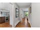 Hallway featuring hardwood floors and views into the kitchen and living spaces at 2717 S Langley Ct, Denver, CO 80210