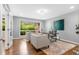 Bright office with a large window, hardwood flooring, comfortable seating, and a stylish area rug at 2717 S Langley Ct, Denver, CO 80210