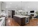 Gourmet kitchen with large island, wine fridge, and open layout to the living room at 2717 S Langley Ct, Denver, CO 80210